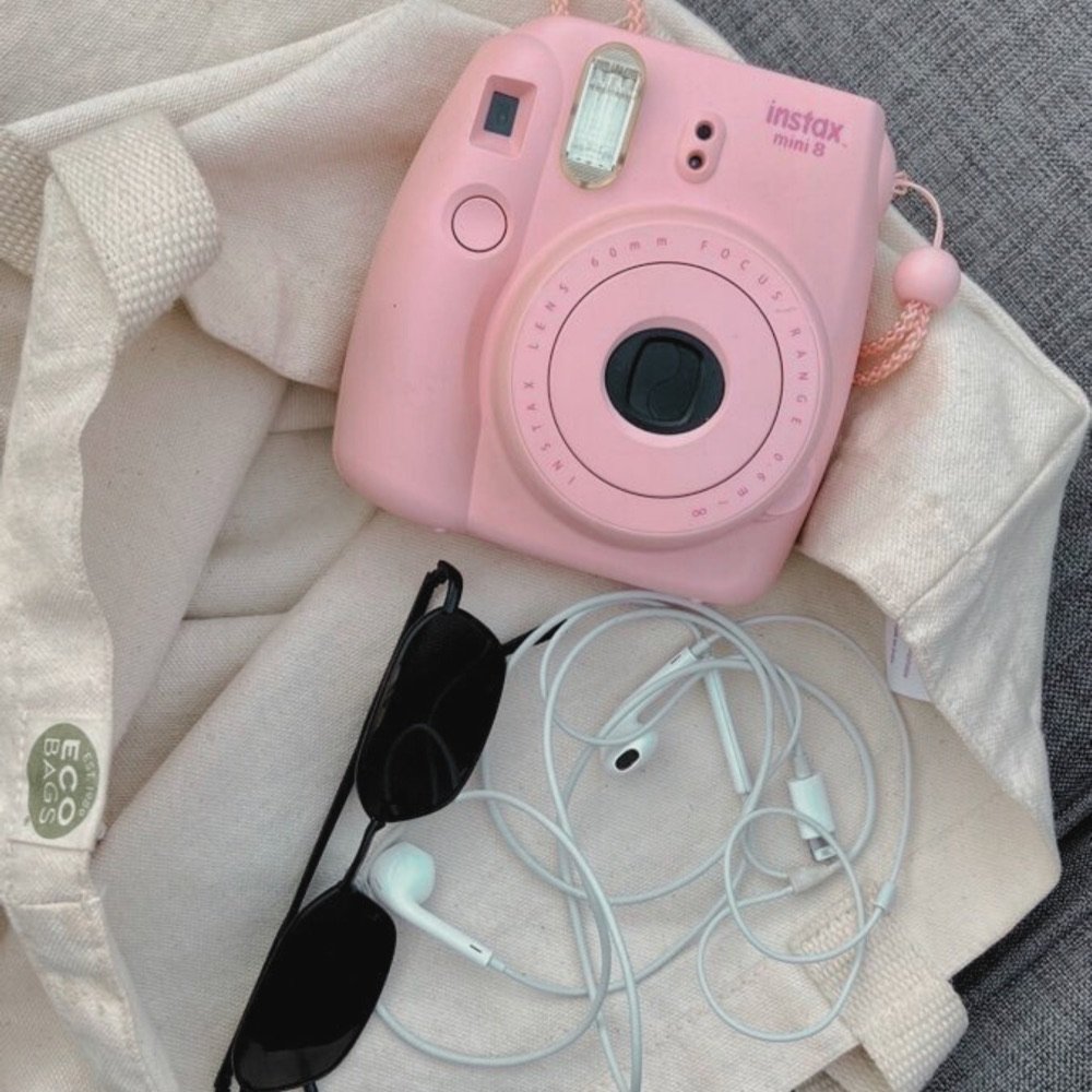 Pink instant camera with sunglasses