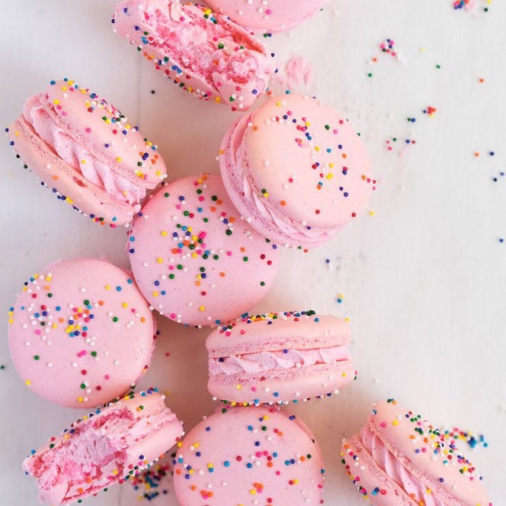 Pile of pink macarons with sprinkles