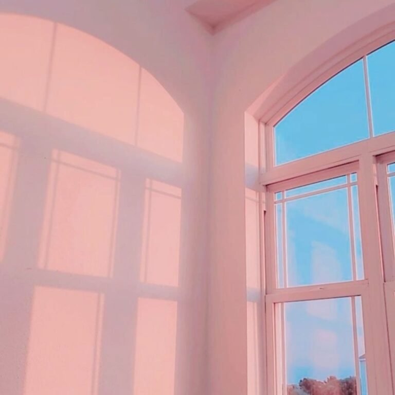 Sunlit pink room with arched windows