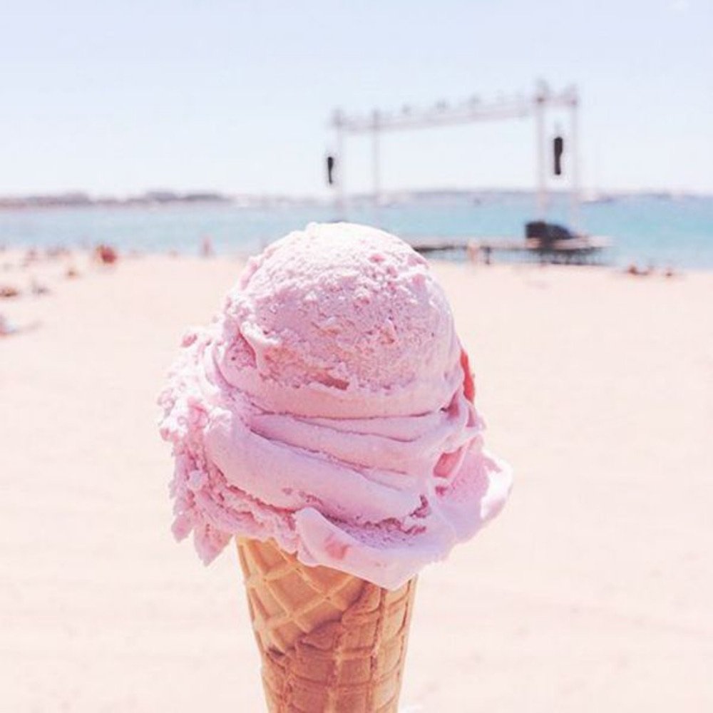 Pink ice cream cone on a sunny beach