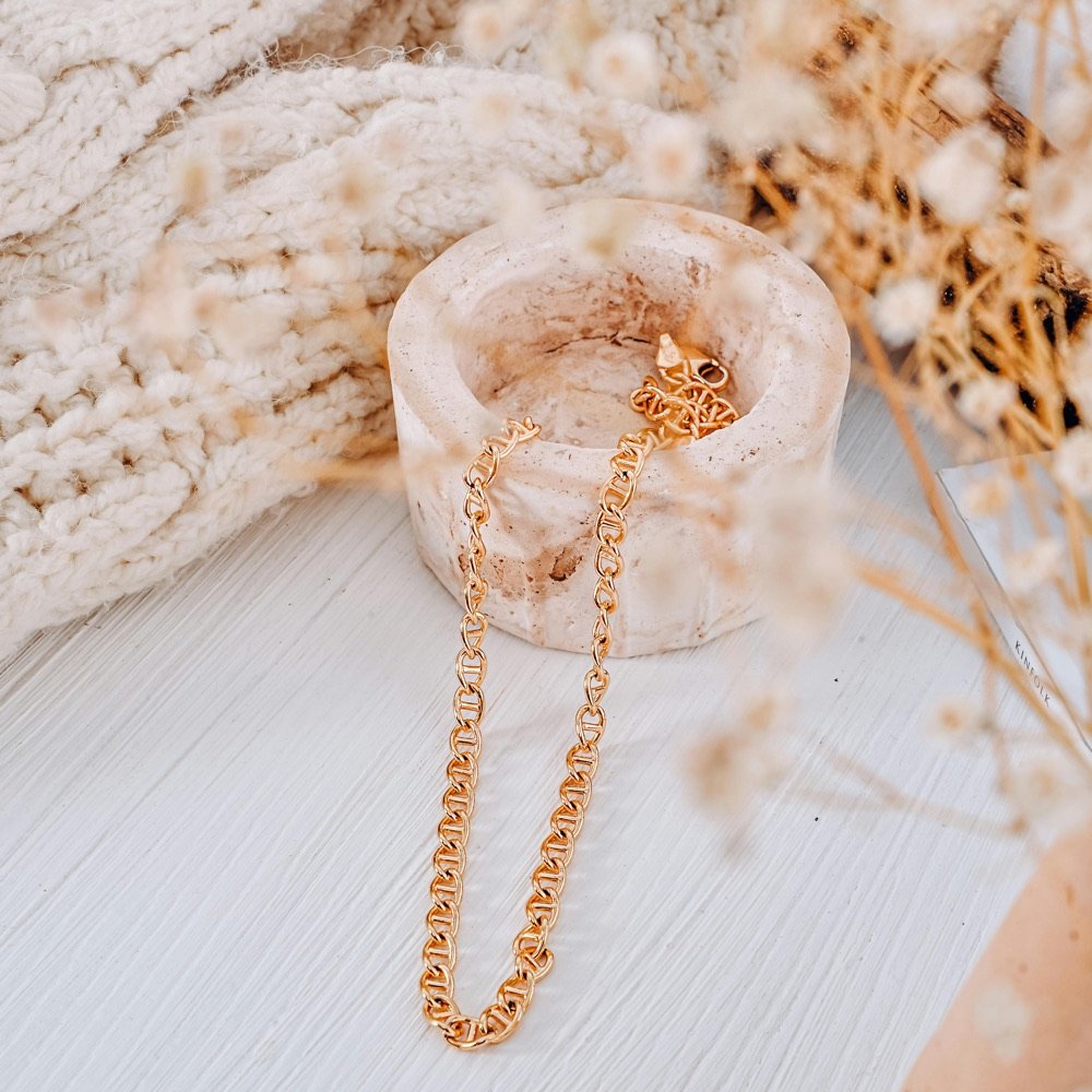 Strands of pearls draped on cream fabric