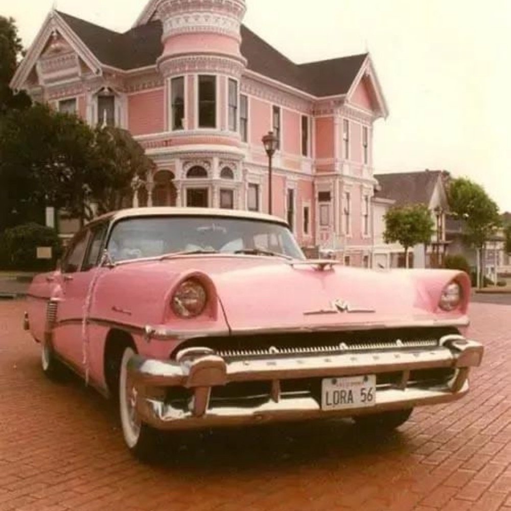 Vintage pink car outside a pink house